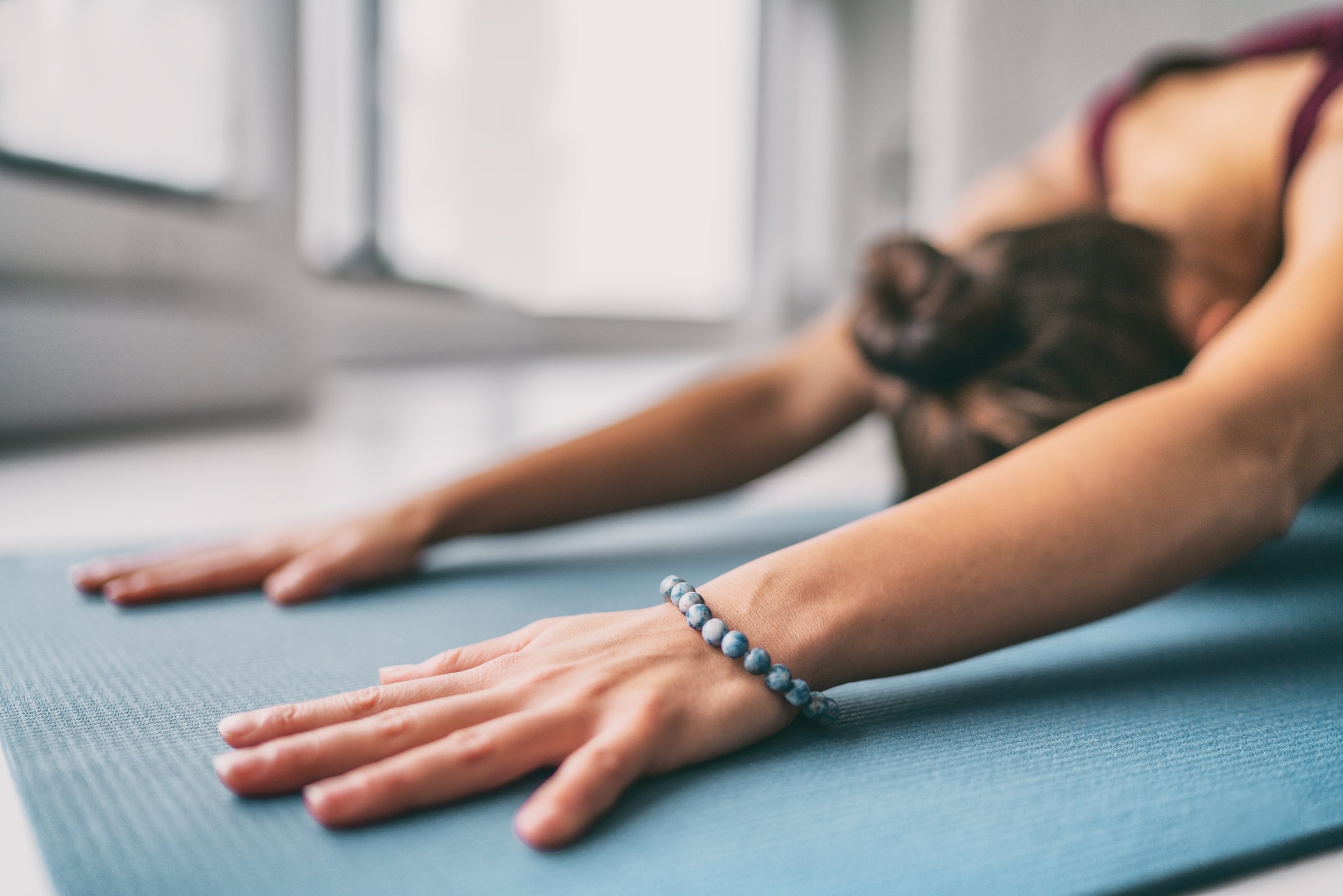 Woman Doing Child Pose Stretch on Yoga Mat