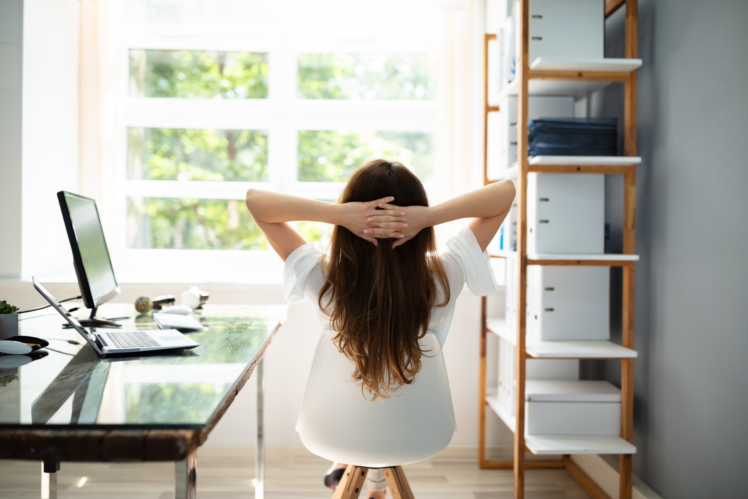 Woman Relaxing by an Office Desk at Home 